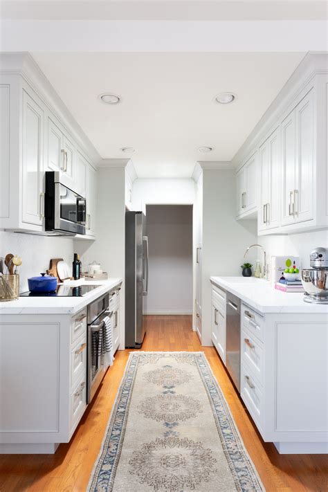 kgalley kitchen white cabinet stainless steel appliances light marble countertop|white galley kitchen designs.